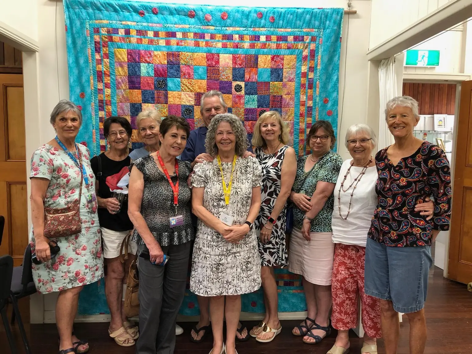 NSACA committee members, quilt background
