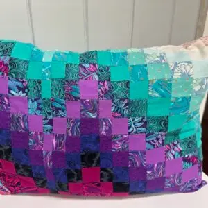 patchwork cushion in pink, purple and turquoise