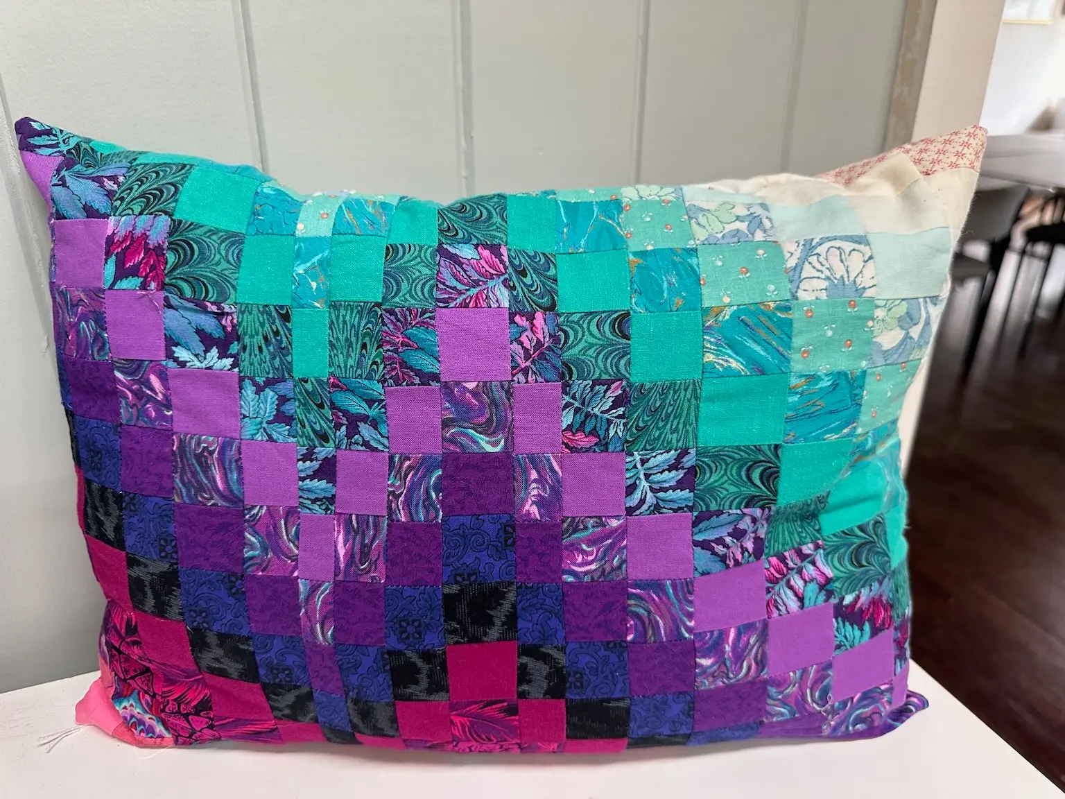 patchwork cushion in pink, purple and turquoise